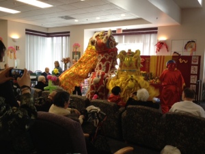 Traditional Lion Dancers perform for 100 participants, in the backdrop is the ancestral altar. 